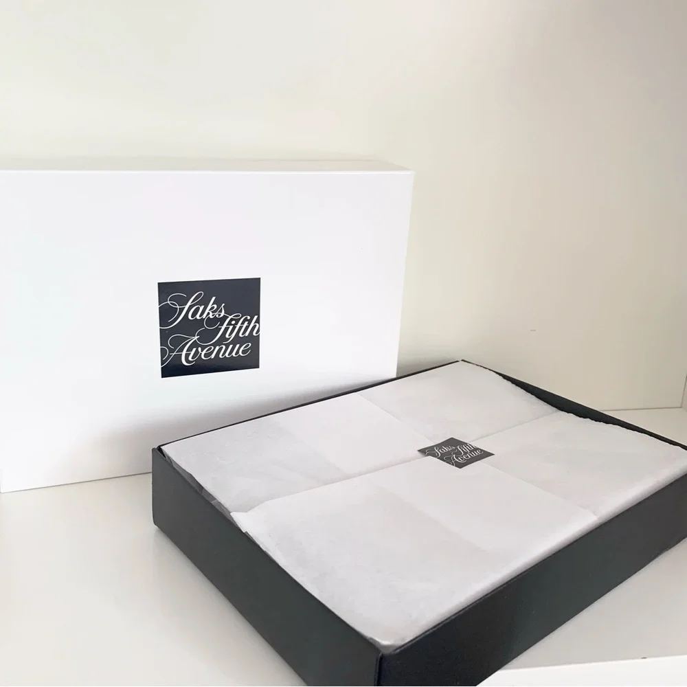 Hold Saks Fifth Avenue gift boxes